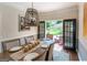Formal dining area boasts elegant lighting and easy access to outdoor living, seamlessly blending indoor and outdoor spaces at 130 Bexar Ct, Johns Creek, GA 30022