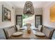Elegant dining room with a large table, stylish chandelier, and views of the outdoor space at 130 Bexar Ct, Johns Creek, GA 30022
