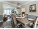 Elegant dining room with a large table, neutral décor, decorative lighting, and seamless access to the living area at 130 Bexar Ct, Johns Creek, GA 30022