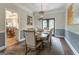 Charming dining room with a decorative light fixture, half wall detail, and seamless flow to the adjacent living area at 130 Bexar Ct, Johns Creek, GA 30022