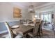 Inviting dining room features a large dining table with seating for six, stylish decor, and hardwood flooring at 130 Bexar Ct, Johns Creek, GA 30022