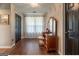 Dressing area features hardwood floors, a chandelier, and a dressing table with three mirrors at 130 Bexar Ct, Johns Creek, GA 30022