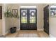 Inviting entryway with double glass doors, neutral paint, decorative plant, and stylish tile flooring at 130 Bexar Ct, Johns Creek, GA 30022
