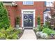 Elegant front entrance showcasing a double door, lovely landscaping, and decorative plants leading up to the doorway at 130 Bexar Ct, Johns Creek, GA 30022