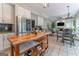 Open kitchen and living area with stainless steel fridge and view to fireplace at 130 Bexar Ct, Johns Creek, GA 30022