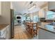 Bright kitchen featuring white cabinetry, granite countertops, and a convenient island with wine rack at 130 Bexar Ct, Johns Creek, GA 30022