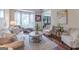 Bright living room featuring neutral-toned furniture, large windows, elegant curtains, and a decorative area rug at 130 Bexar Ct, Johns Creek, GA 30022