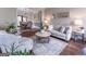 Comfortable living room with hardwood floors, neutral furnishings, decorative accents, and dining area access at 130 Bexar Ct, Johns Creek, GA 30022