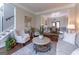 Stylish living room with hardwood floors, staircase, and open dining area at 130 Bexar Ct, Johns Creek, GA 30022