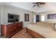 Spacious main bedroom features wood floors, a ceiling fan, and a large dresser with a TV at 130 Bexar Ct, Johns Creek, GA 30022