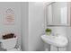 Practical half bathroom features sleek pedestal sink, toilet, and minimalist decor at 495 Stonehaven Dr, Fayetteville, GA 30215