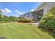 Lush green backyard with a view of the screened-in porch area and the nearby lake at 316 Kensington Dr, Peachtree City, GA 30269