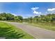 Paved walking path along a beautiful pond surrounded by lush greenery and mature trees, offering serene views at 316 Kensington Dr, Peachtree City, GA 30269