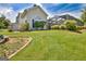 Well-manicured backyard featuring lush green grass, professional landscaping, and a screened-in porch at 316 Kensington Dr, Peachtree City, GA 30269