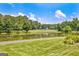 Enjoy the beautiful backyard view with a serene lake, lush trees, and a golf course at 316 Kensington Dr, Peachtree City, GA 30269