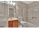 Compact bathroom featuring a tub-shower combination, vanity with a classic oak cabinet, and neutral-toned decor at 316 Kensington Dr, Peachtree City, GA 30269