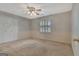 Bright bedroom with neutral tones, a ceiling fan, a large window with shutters, and a spacious closet at 316 Kensington Dr, Peachtree City, GA 30269