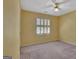 Bright, cheerful bedroom with yellow walls, plush carpet, and a window with shutters, offering comfort and style at 316 Kensington Dr, Peachtree City, GA 30269