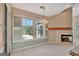 Bright dining area with fireplace and windows overlooking the pool at 316 Kensington Dr, Peachtree City, GA 30269