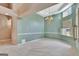 Well-lit dining area has a chandelier and large windows with views to the outdoor area at 316 Kensington Dr, Peachtree City, GA 30269