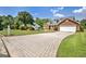 Paver driveway leading to a well-maintained single-Gathering home with lush green landscaping at 316 Kensington Dr, Peachtree City, GA 30269