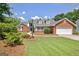 Beautiful single-Gathering home with a well-manicured lawn, brick accents and a two-car garage at 316 Kensington Dr, Peachtree City, GA 30269