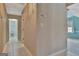 Inviting hallway featuring tiled floors, neutral walls, and views into a bathroom and a bright, naturally lit room at 316 Kensington Dr, Peachtree City, GA 30269