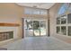 Sunlit living area with fireplace and large windows overlooking the pool area at 316 Kensington Dr, Peachtree City, GA 30269
