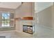 Open-concept living area with fireplace, tile floors, and pool view at 316 Kensington Dr, Peachtree City, GA 30269