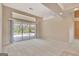 Living room with sliding glass doors offering a view of the screened-in pool area at 316 Kensington Dr, Peachtree City, GA 30269