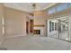 Cozy living room with fireplace, sliding glass door to the patio and pool at 316 Kensington Dr, Peachtree City, GA 30269