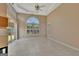 Living room with tray ceiling, ceiling fan, and a view of the exterior at 316 Kensington Dr, Peachtree City, GA 30269
