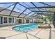 The screened-in pool has a spa, nearby windows, and an ample seating area at 316 Kensington Dr, Peachtree City, GA 30269