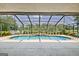 Relaxing screened-in pool area surrounded by lush greenery and offering plenty of seating at 316 Kensington Dr, Peachtree City, GA 30269