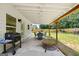 Back patio with stone pavers, lighting, wooden beams, and a barbeque grill at 9477 Forest Knoll Dr, Jonesboro, GA 30238