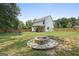 Large backyard with a fire pit, lawn and patio area great for entertaining at 9477 Forest Knoll Dr, Jonesboro, GA 30238