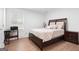 Cozy bedroom with wood floors, complemented by natural light from the window at 9477 Forest Knoll Dr, Jonesboro, GA 30238