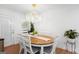 Bright dining room features an elegant chandelier and natural light at 9477 Forest Knoll Dr, Jonesboro, GA 30238