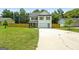 Two-story home with a spacious front yard and driveway, light blue front door and wood fence at 9477 Forest Knoll Dr, Jonesboro, GA 30238