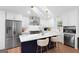Modern kitchen featuring stainless steel appliances, white cabinets, and a stylish island with bar stool seating at 9477 Forest Knoll Dr, Jonesboro, GA 30238