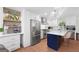 Modern kitchen featuring stainless steel appliances, white cabinets, and a stylish island with pendant lighting at 9477 Forest Knoll Dr, Jonesboro, GA 30238