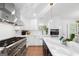 Bright kitchen featuring stainless steel Viking appliances, white cabinets, and a stylish island at 9477 Forest Knoll Dr, Jonesboro, GA 30238