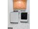 Clean laundry room with Samsung washer and dryer and neutral cabinets at 9477 Forest Knoll Dr, Jonesboro, GA 30238