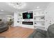 Modern living room features a fireplace, custom shelving, and comfortable seating with natural light at 9477 Forest Knoll Dr, Jonesboro, GA 30238