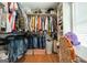 Spacious walk-in closet with shelves, hanging rods, and window letting in natural light at 9477 Forest Knoll Dr, Jonesboro, GA 30238