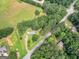 Aerial view of a home with a yard, deck, and shed surrounded by trees at 1041 Sandy Ridge Rd, Mcdonough, GA 30252