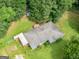 Aerial view of a home with a large yard, deck, and shed surrounded by trees at 1041 Sandy Ridge Rd, Mcdonough, GA 30252