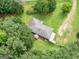 Home with a large yard, deck, and shed surrounded by trees at 1041 Sandy Ridge Rd, Mcdonough, GA 30252