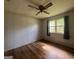 This bedroom features a ceiling fan and a large window at 1041 Sandy Ridge Rd, Mcdonough, GA 30252