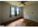 Cozy bedroom with wood-look floors and natural light from two windows at 1041 Sandy Ridge Rd, Mcdonough, GA 30252